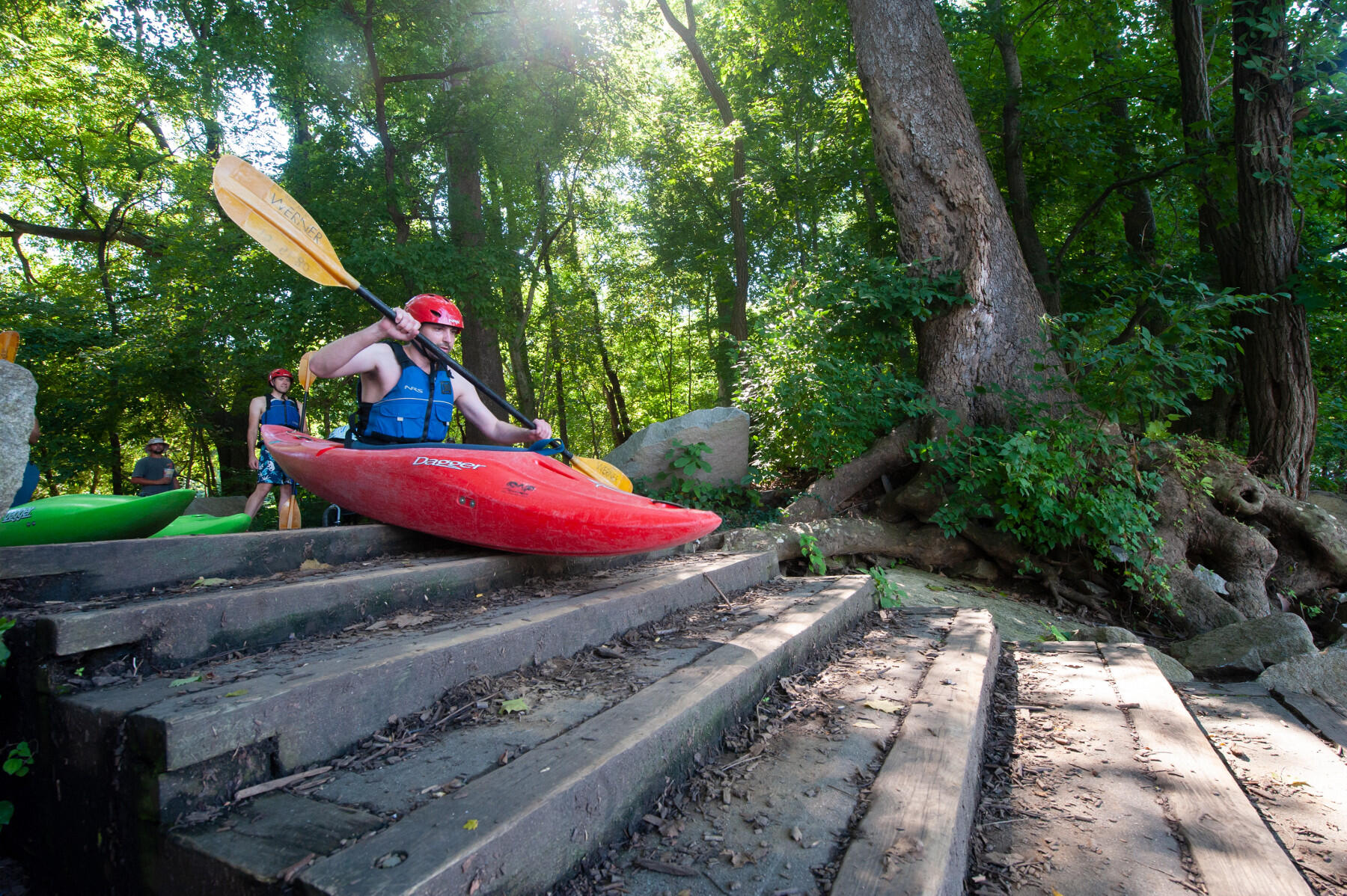 Kent Fairchild, a student in VCU's M.D.-Ph.D. program, practices a seal entry at a Kayak launch in Pony Pasture. (Photo by Tom Kojcsich, University Relations)