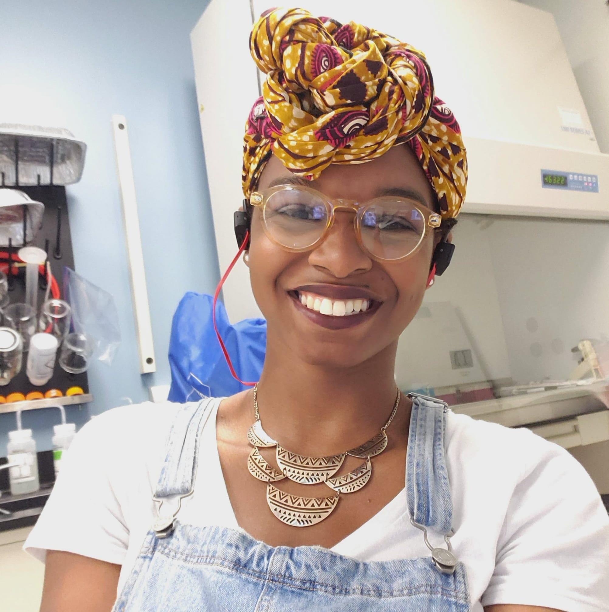Briana James, Ph.D. smiling in a lab