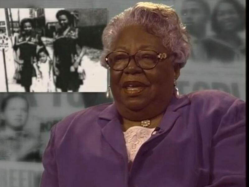 A photo of a woman speaking with a smaller black and white photo of two women to the left of her head.