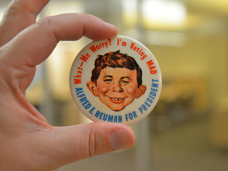A button with Mad Magazine figure Alfred E. Neuman with \"What-Me Worry? I'm voting MAD\" encircling the top of the button and \"ALFRED E. NEUMAN FOR PRESIDENT\" encircling the bottom.