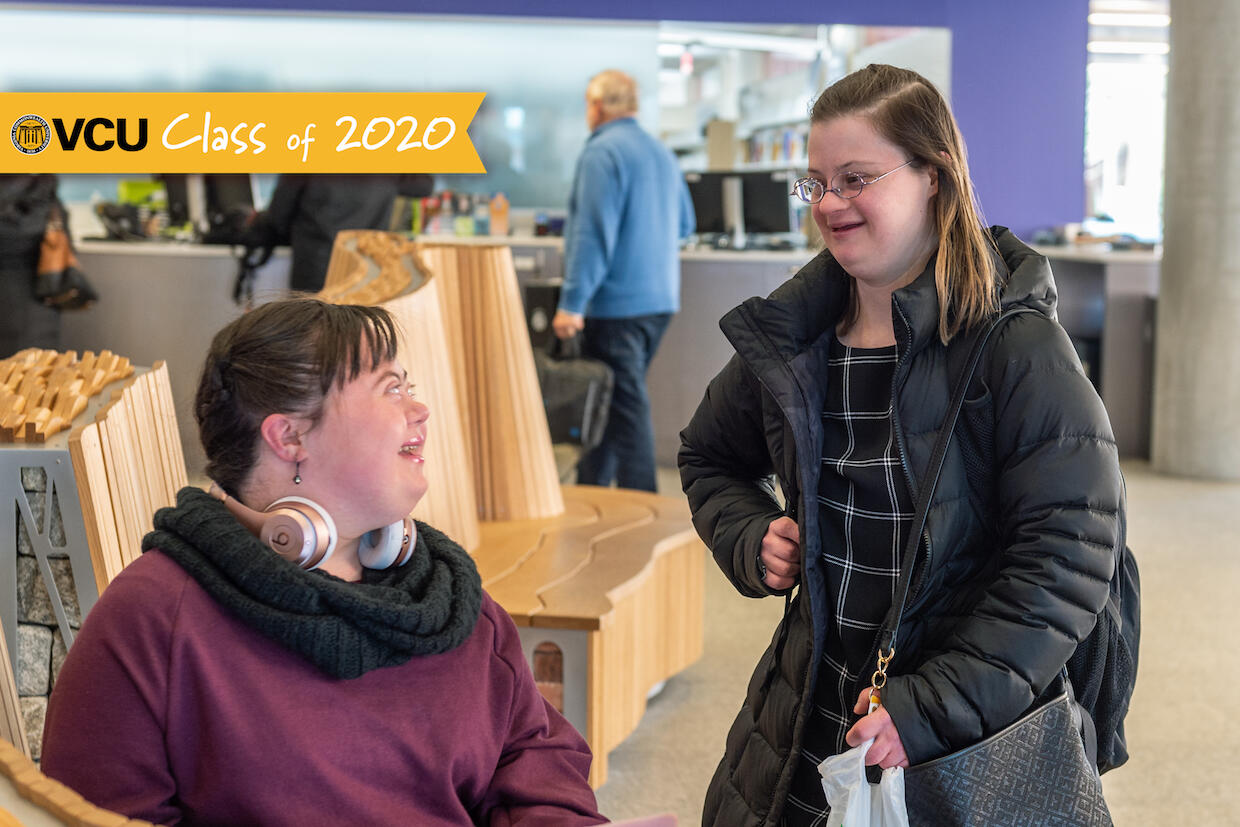 Two students in conversation inside V C U's Cabell Library.
