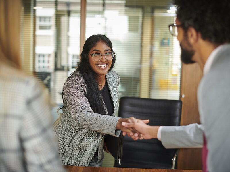 A photo of a man and women shaking hands 