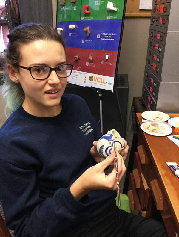 VCU alumna Brenna Geraghty paints a replica German-made jar with rabbit design that was 3-D-printed in the Virtual Curation Laboratory.
