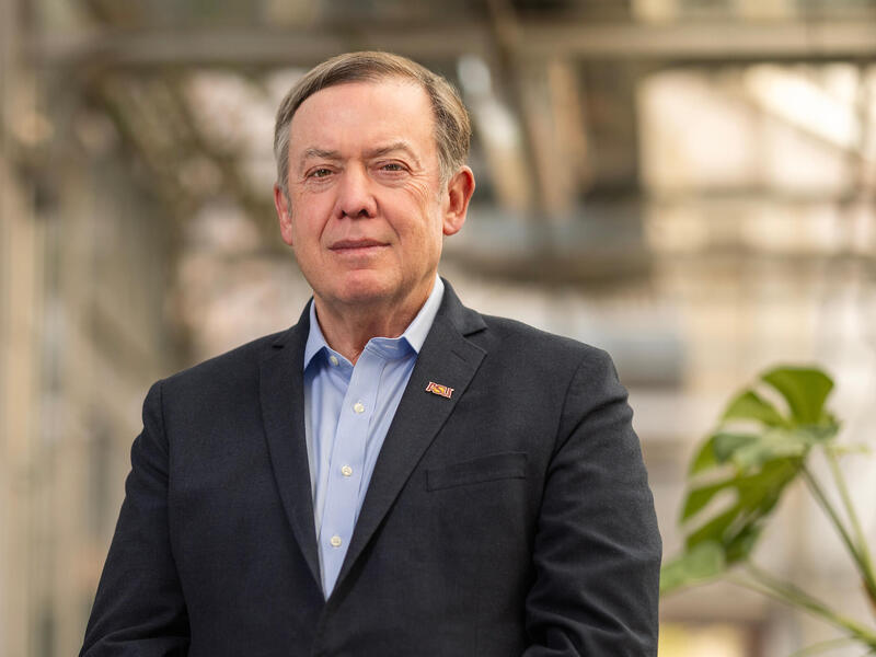 A man in a suit jacket and blue shirt.