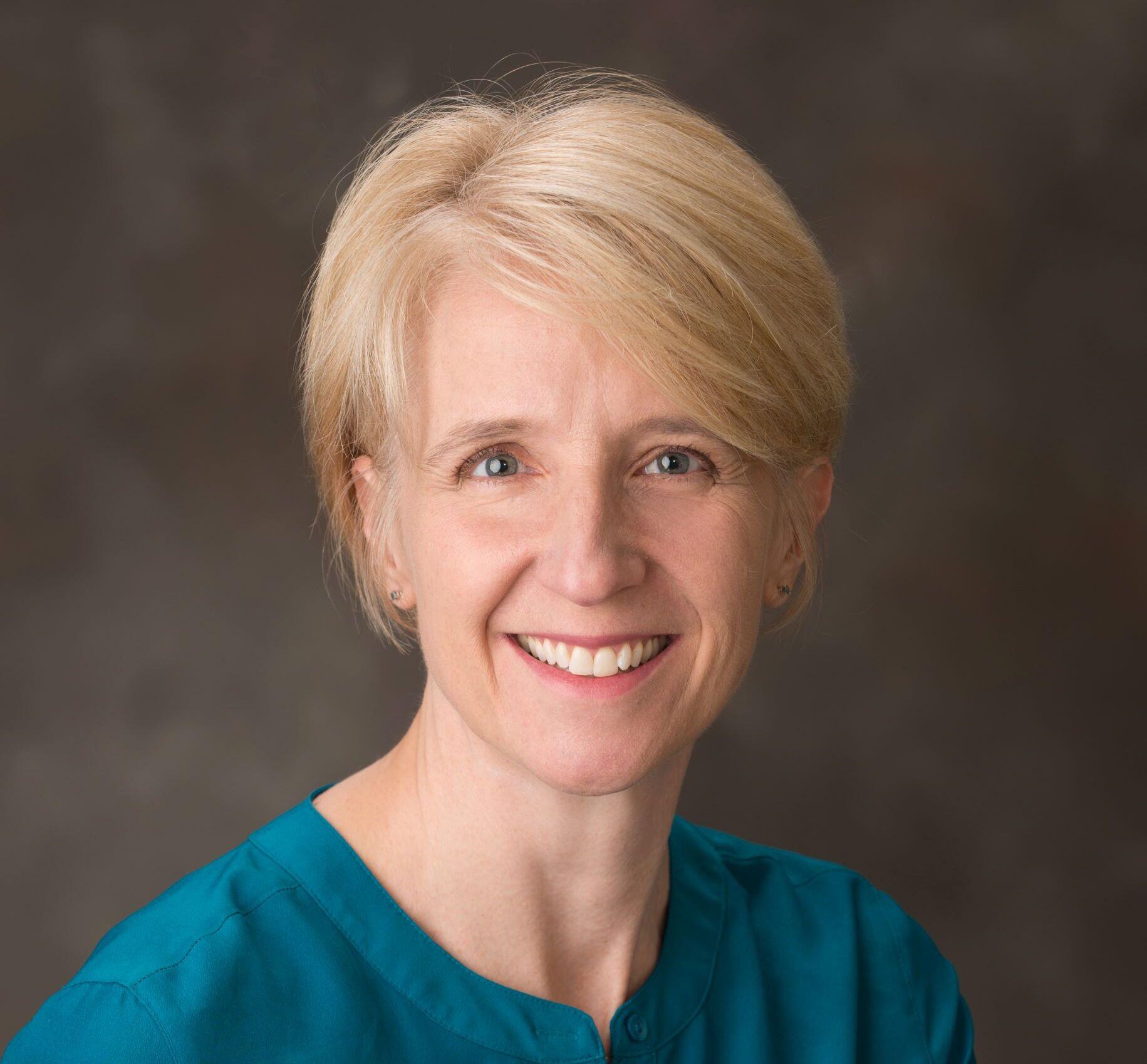 A smiling head shot portrait of Kathleen Rudasill