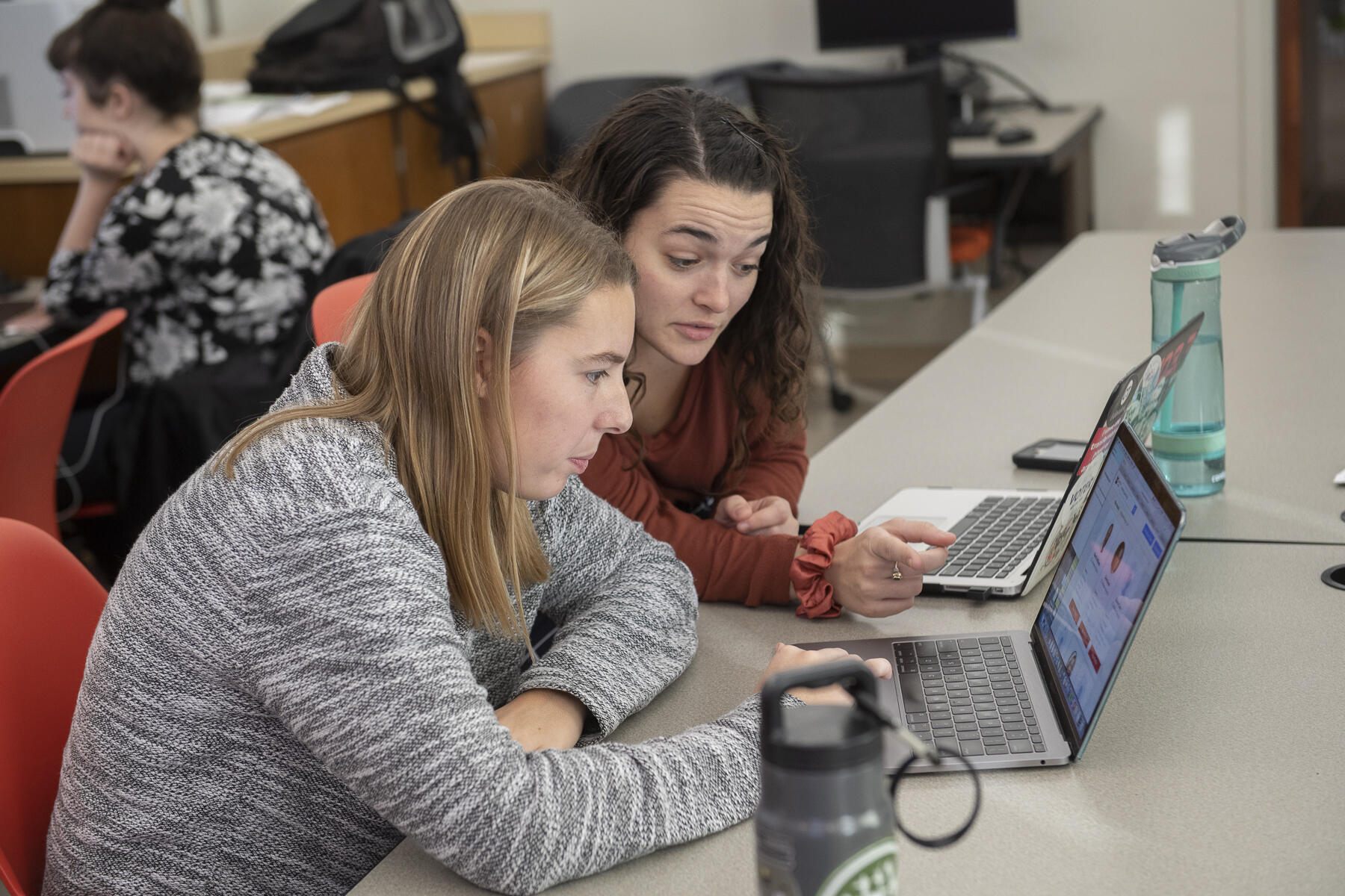Two students looking at a computer.