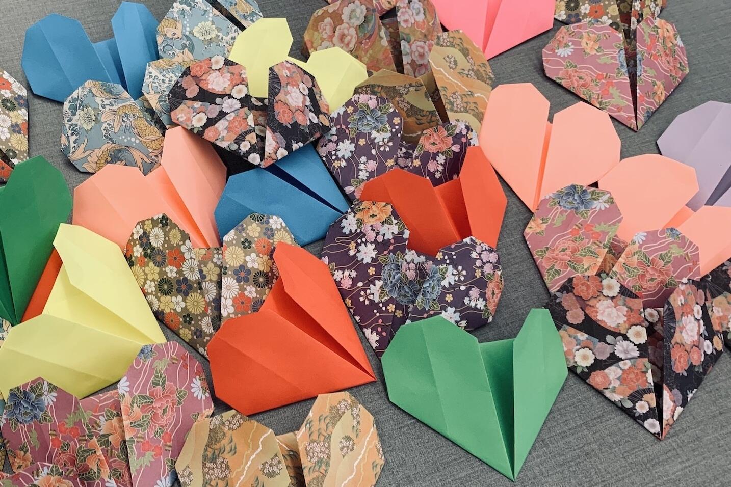 Paper origami hearts on a table.