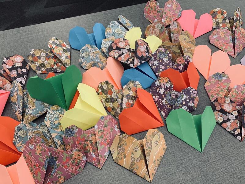 Paper origami hearts on a table.