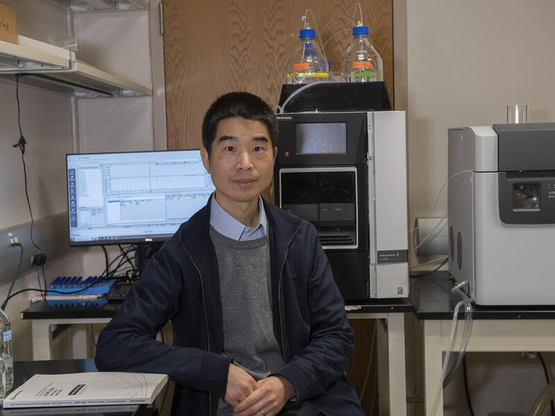 A man sitting in front of equipment. 