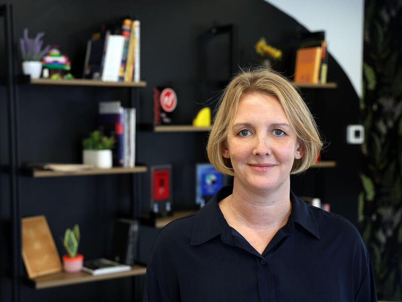 A photo of a woman from the shoulders up. 