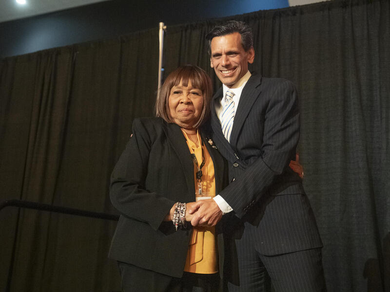 Yvonne Jones and Michael Rao stand side by side and smile for the camera.