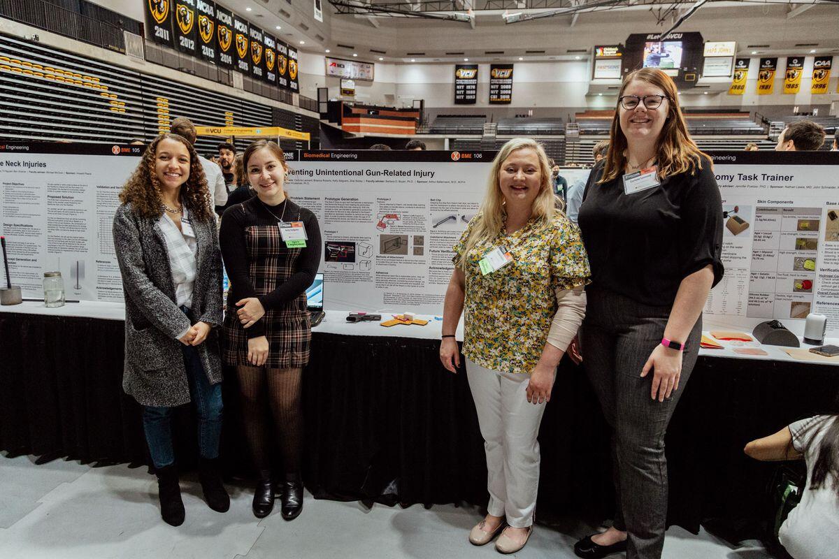 (Left to right) Zoie Sickey, Kelly Salguero, Brianna Roberto and Corinne Leonard standing in front of their presentation. 