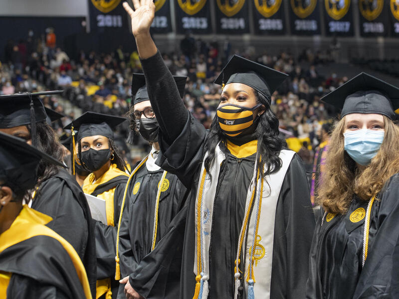 graduates waving at commencement