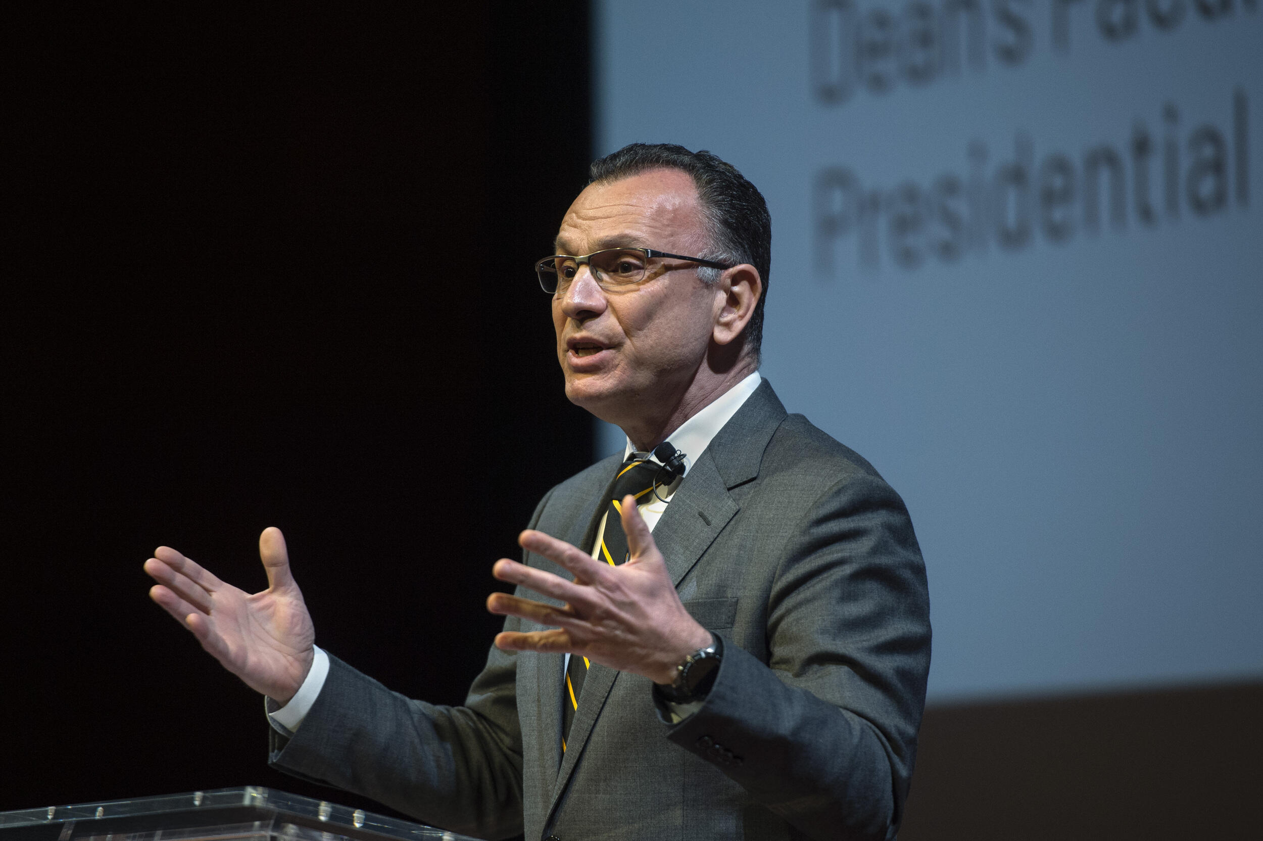 Fotis Sotiropoulos, Ph.D., provost and senior vice president for academic affairs at VCU, delivering the university’s inaugural State of Academic Affairs Address wearing a grey suit and looking to the left