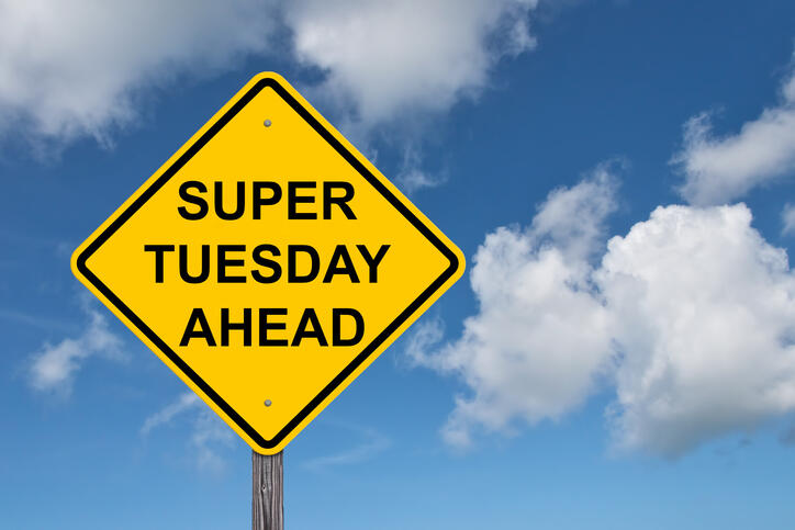 A photo of a yellow caution sign that says \"SUPER TUESDAY AHEAD\" 
