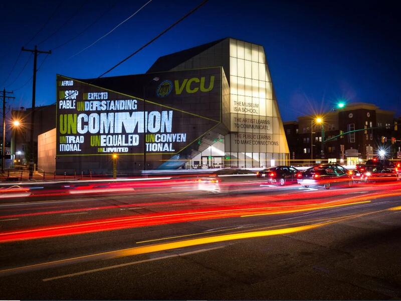 A photo of the ICA building lit up at night 