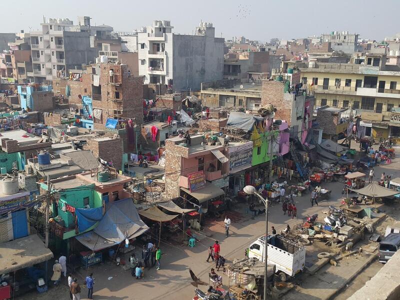 a crowded slum during the day in Delhi, India.