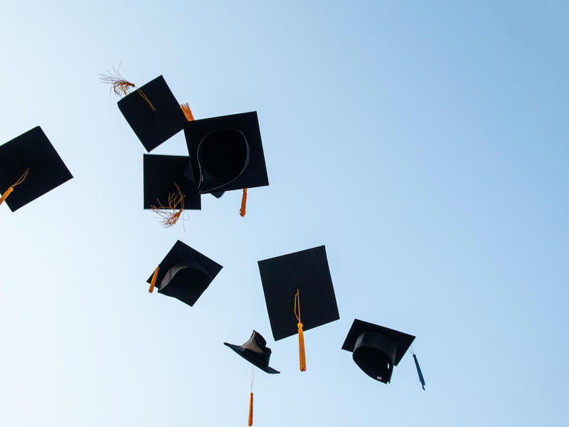 graduation caps thrown in the air