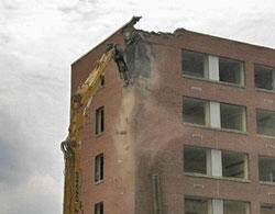 First 15 Minutes. Chunks of brick and debris rain down from the first corner targeted by the demolition team, who will spend two to three weeks to bring down the building. Water was used to wet Randolph-Minor and subsequent debris to limit the amount of dust in the area.

Photos by Michael Ford, University News Services