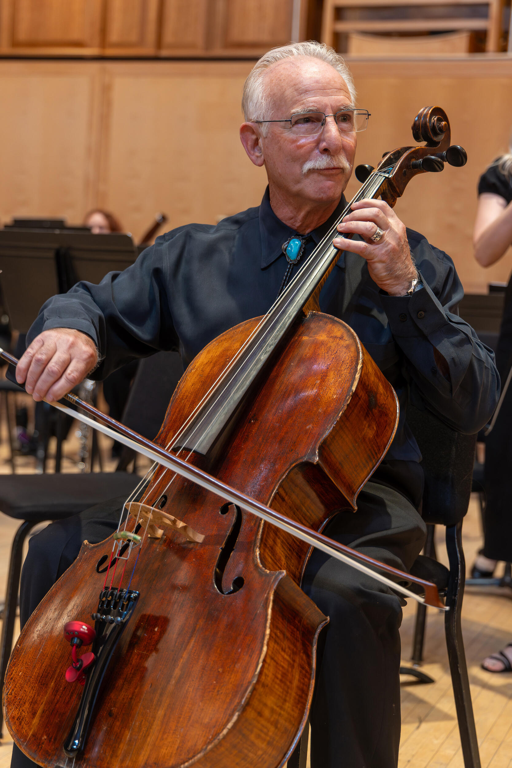 A photo of a man playing a double bass. 