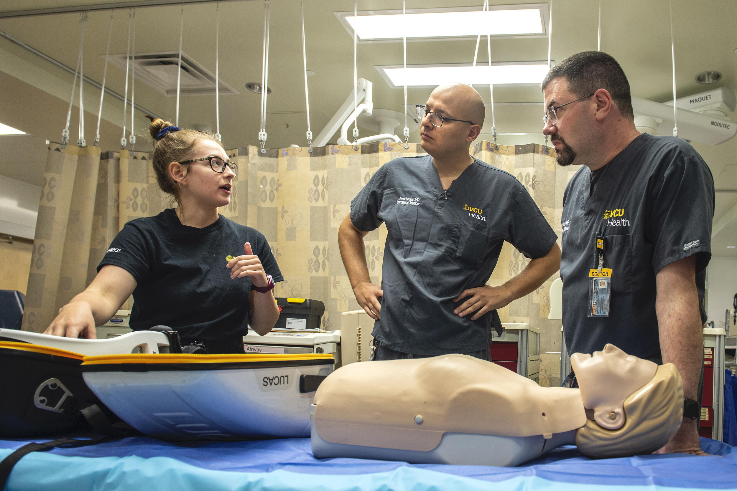 Kaylee Eckert and Amir Louka, M.D., emergency medicine physician, walk through the trauma bay at VCU Medical Center.