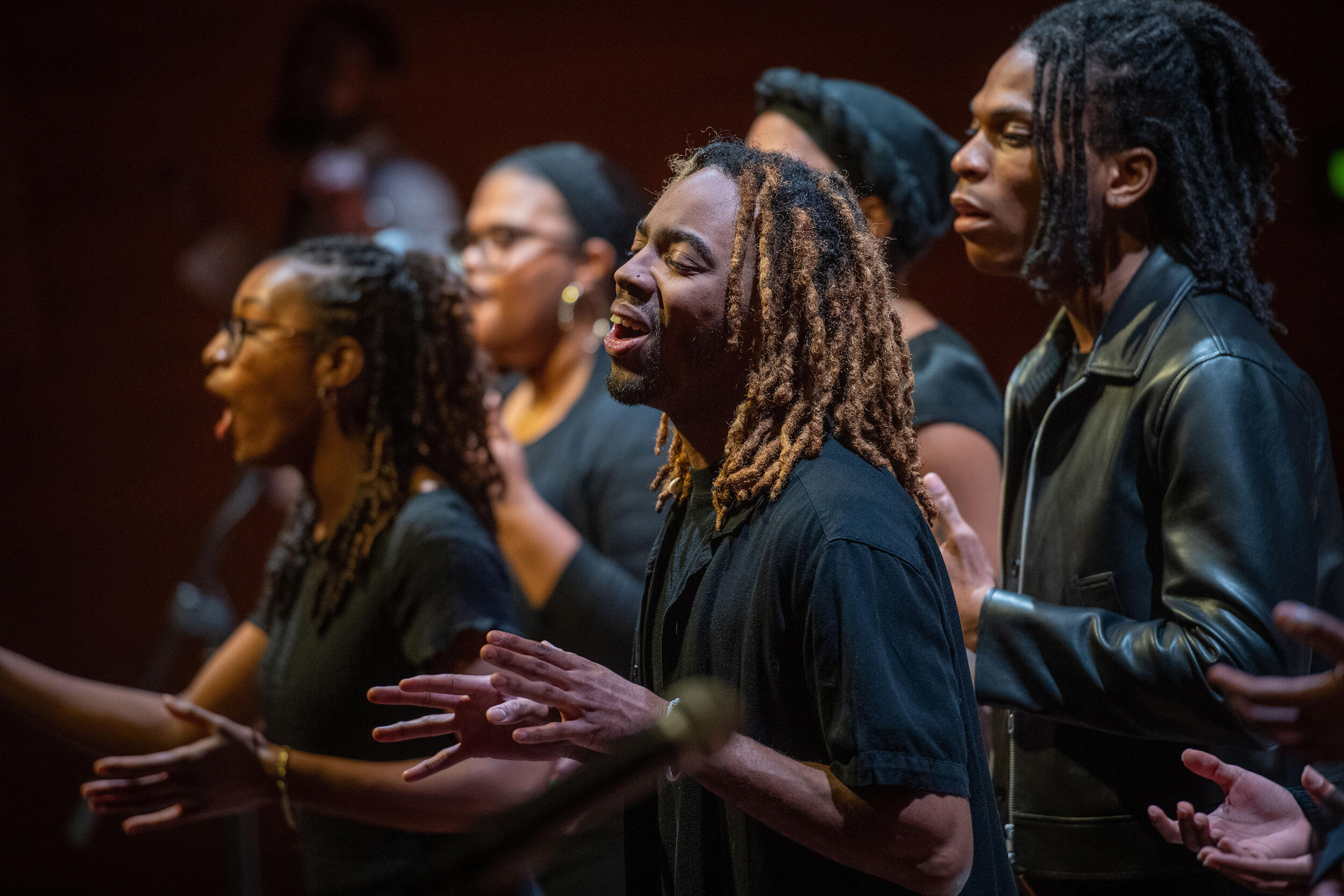 A photo of five people singining. 