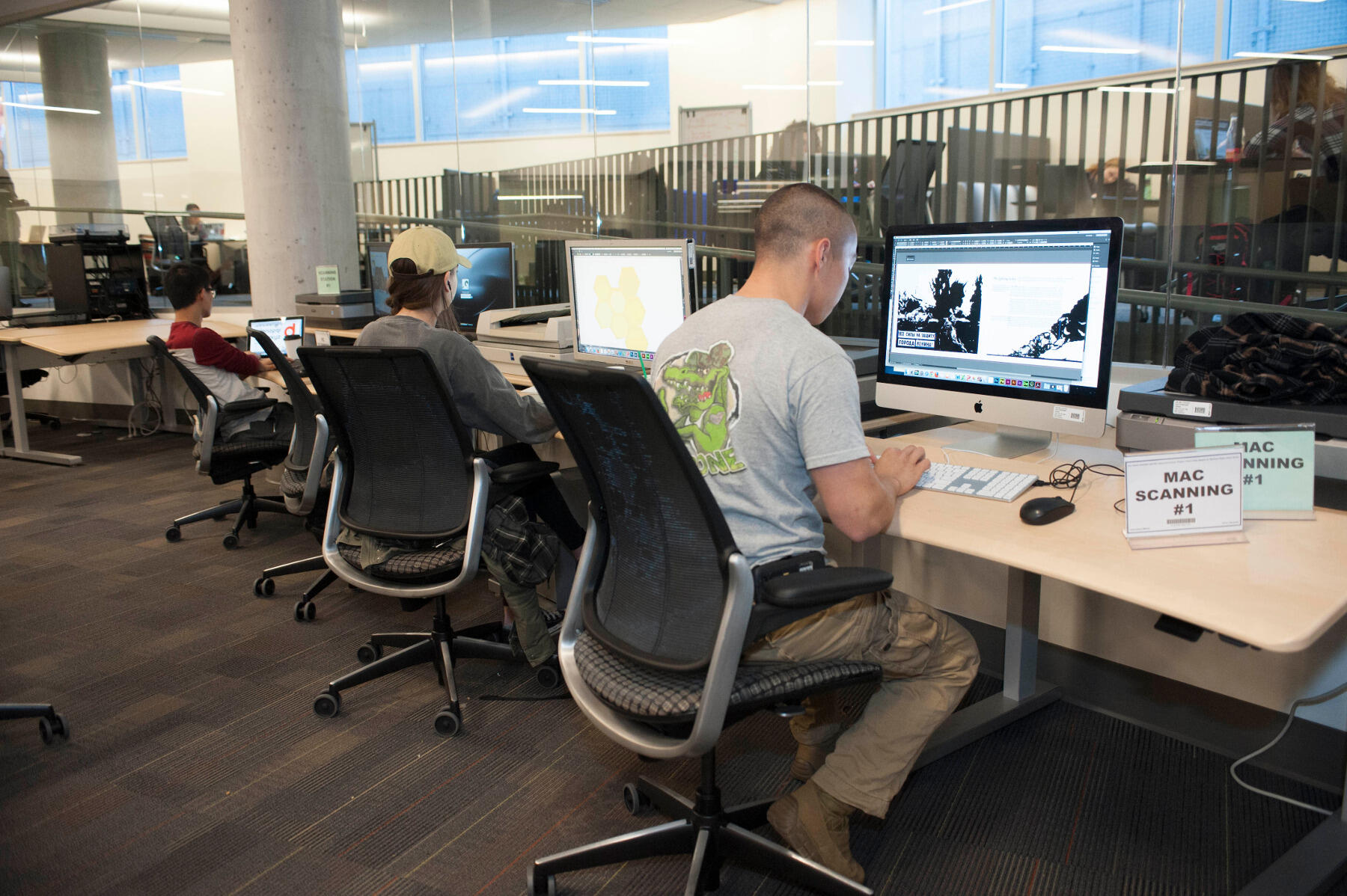 Students work on class projects at a scanning workstation in The Workshop.