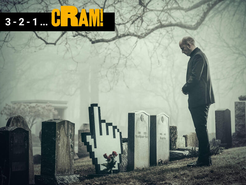A photo of a man looking sadly down at tomb stones. The one he is looking directly at is shaped like a pixilated hand with the index finger pointed upwards. In the upper left corner is white and yellow text on a black triangle that reads \"3 -2 - 1 ... cRAM!\"