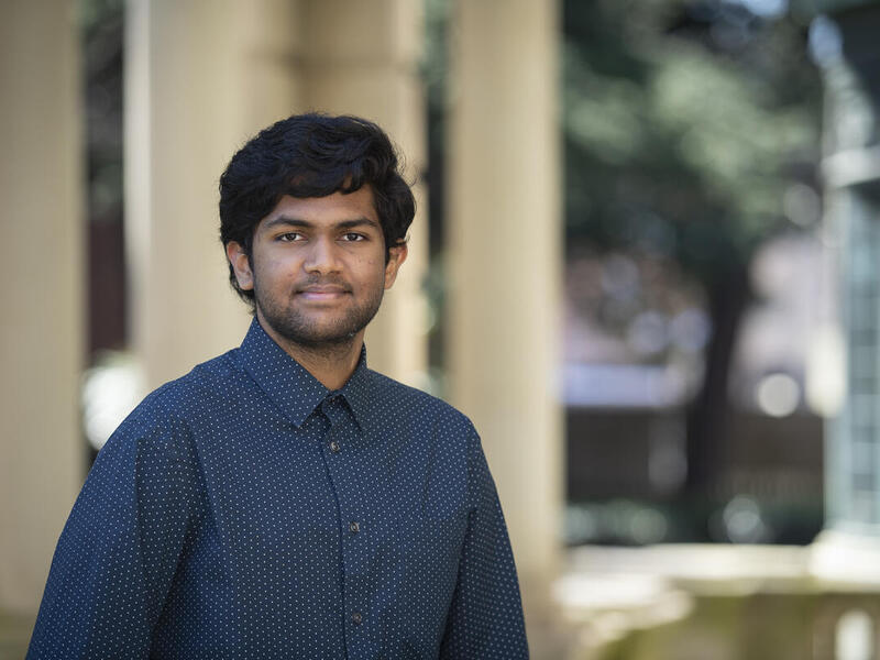 Vineeth Vaidyula wearing a blue button down shirt with a blurred background