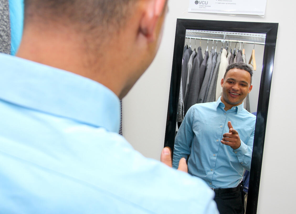 Hetrick, photographed here at the "Suit Yourself" closet, is helping organize an event March 25 that will provide VCU students with a 40 percent discount shopping day at JCPenney. (Photo credit: Pat Kane)