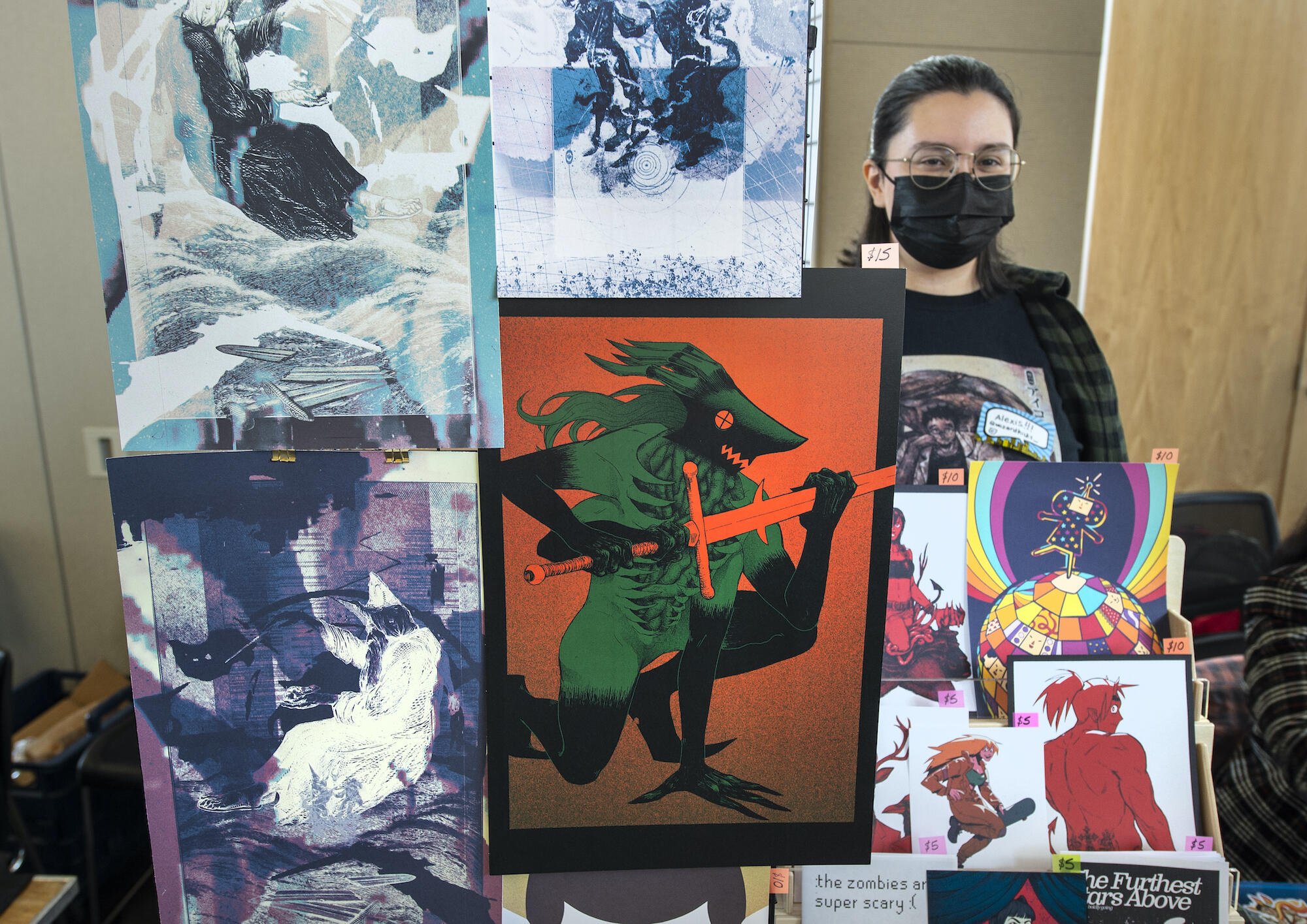 Alexis DeJesus, VCU graduate in graphic design, with her work at the Richmond Indie Comic Expo. 