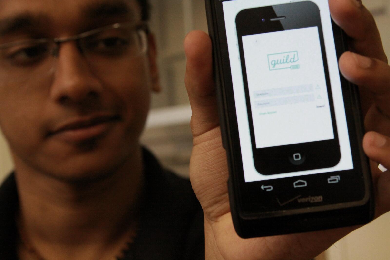 Munif Saza, the da Vinci Works teaching assistant, shows off his company's app, Guild, which will link small business owners and entrepreneurs with freelance service providers, such as graphic designers, web developers and marketing professionals. 