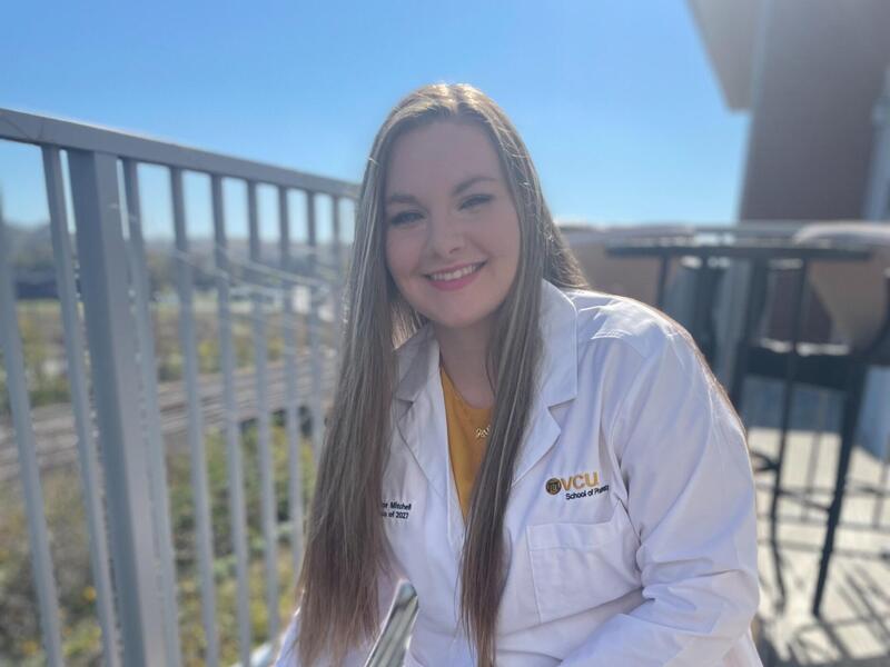 A photo of a woman sitting with a dog. 