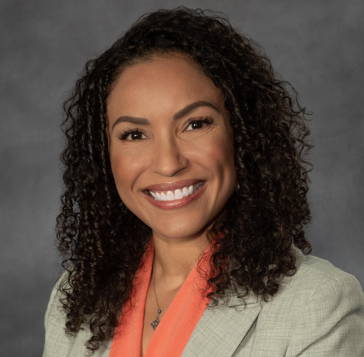A photo of a woman from the shoulders up. 