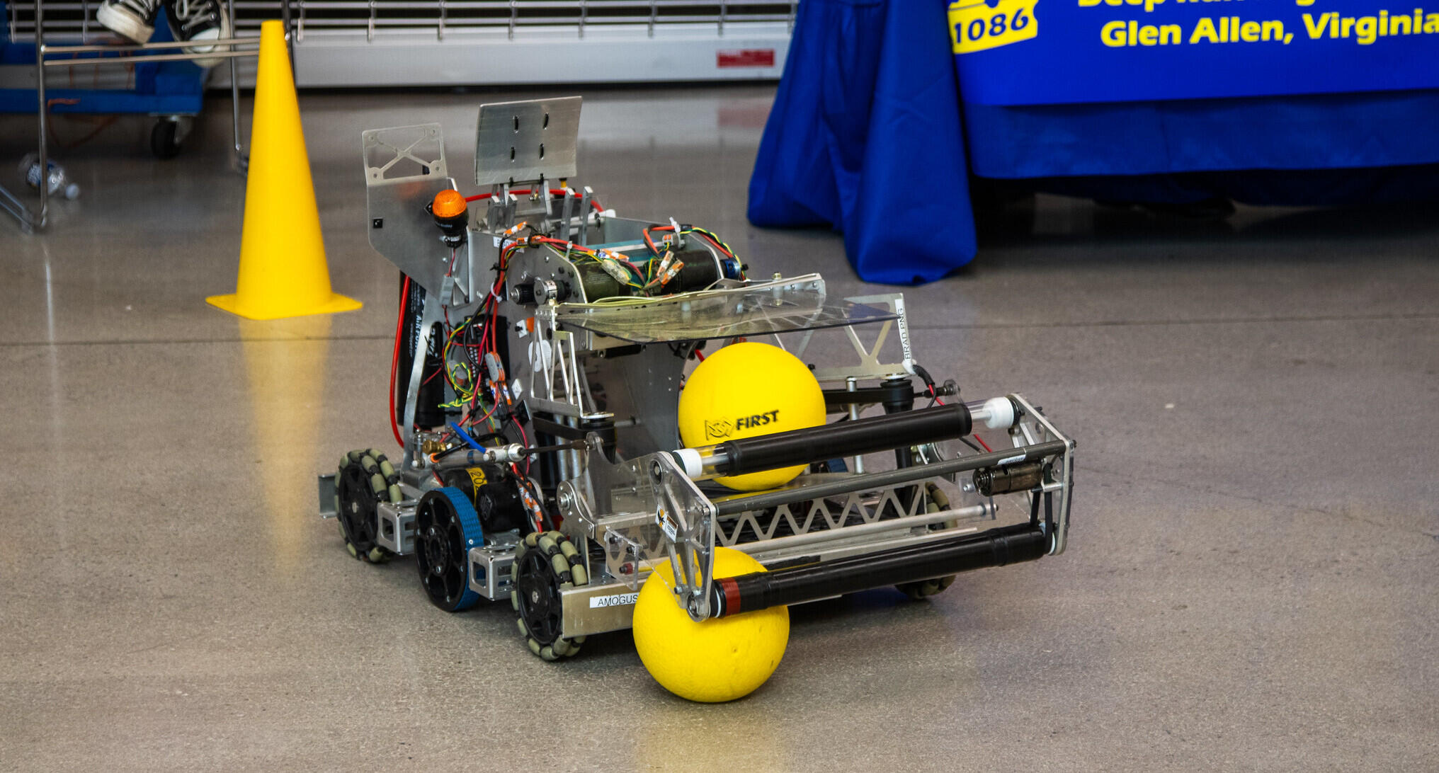 A photo of a small robot on the gorund. 