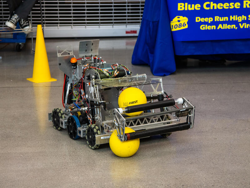 A photo of a small robot on the gorund. 