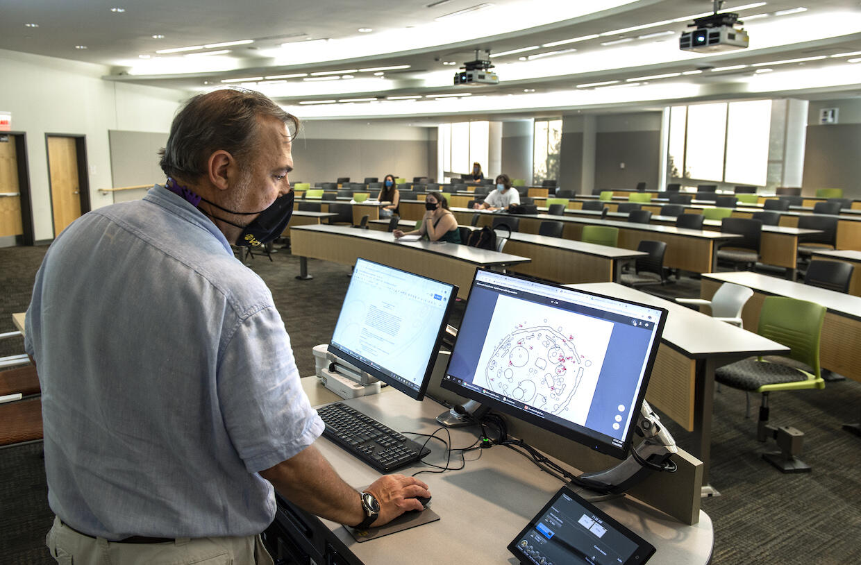 Faculty member teaches classes during the COVID-19 pandemic. Everyone is wearing a face mask