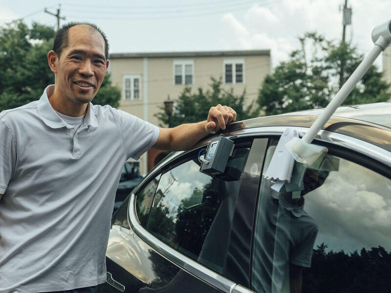 VCU College of Engineering chemical and life science engineering professor Stephen S. Fong affixes a monitor on his car to measure local ozone pollution.