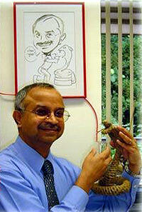 R. Manjunatha Kini, Ph.D., in his lab with friend. Image courtesy of Syed Rehana/National University of Singapore.