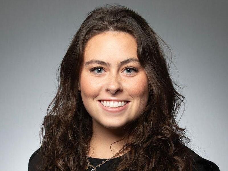 A photo of a woman from the shoulders up. 