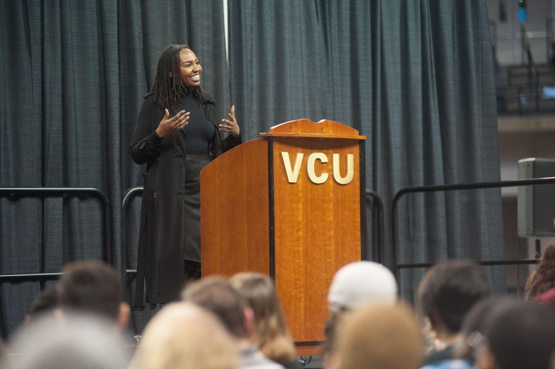 Opal Tometi addresses an estimated 1,100 attendees at the Siegel Center.
<br>Photo by Steven Casanova, University Marketing.
