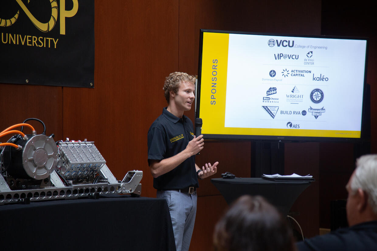 Business student Harrison Powers thanks Hyperloop at VCU's sponsors at the unveiling of the pod vehicle. (Photo by Alexandria Tayborn, VCU College of Engineering)
