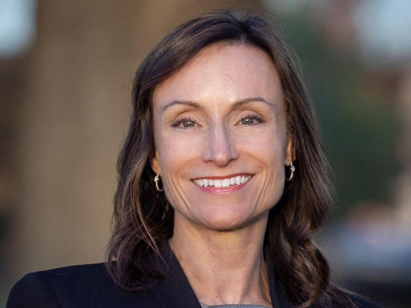 A photo of a woman from the shoulders up. 