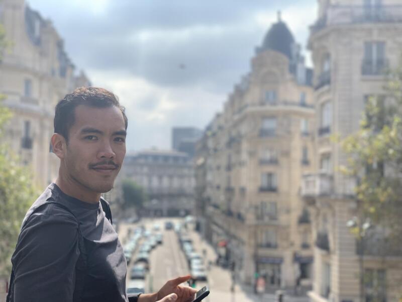 A man standing in front of a city street 