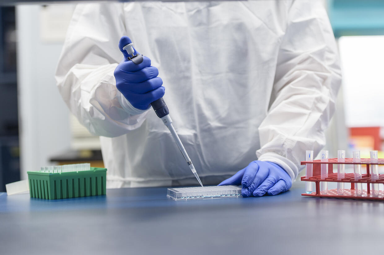 A School of Pharmacy researcher distributes liquids into a dish