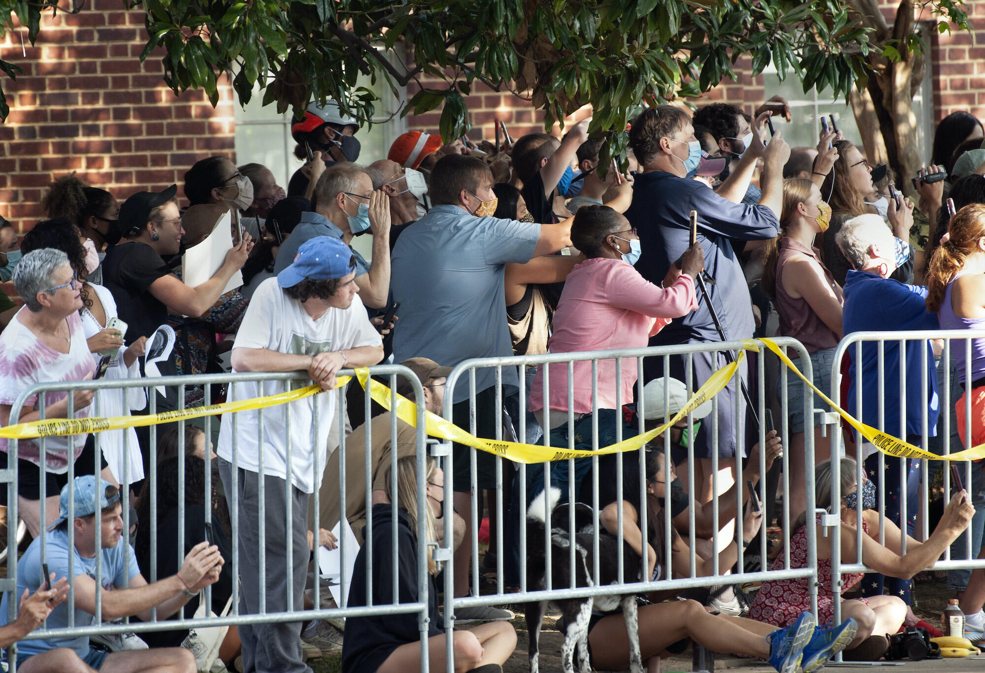 A crowd of people gathers to watch the removal of the Robert E. Lee statue