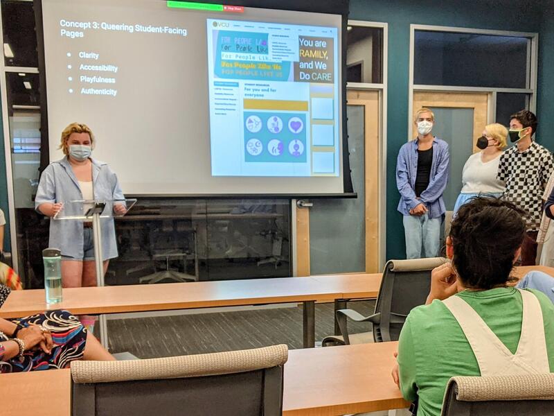 A student giving a presentation in front of a projection. 