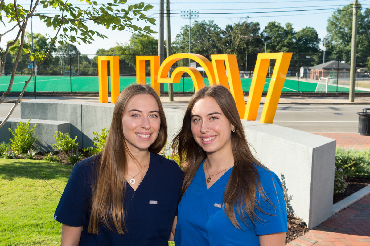 A portrait of two women in medical scrubs 