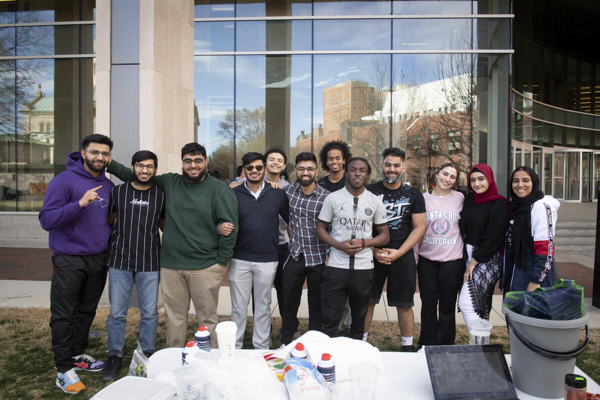 Twelve students standing in front of the Cabbel Library 