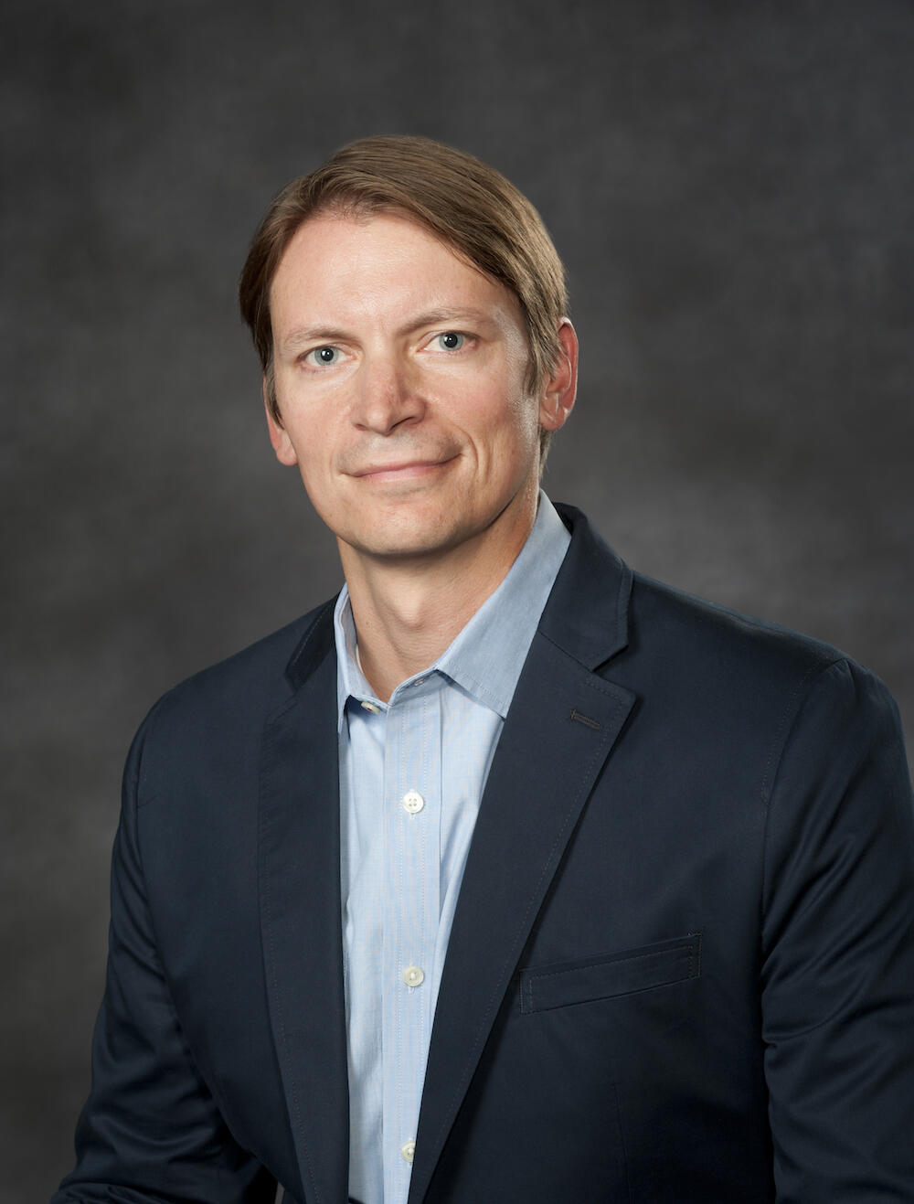 A photo of a man from the chest up. 